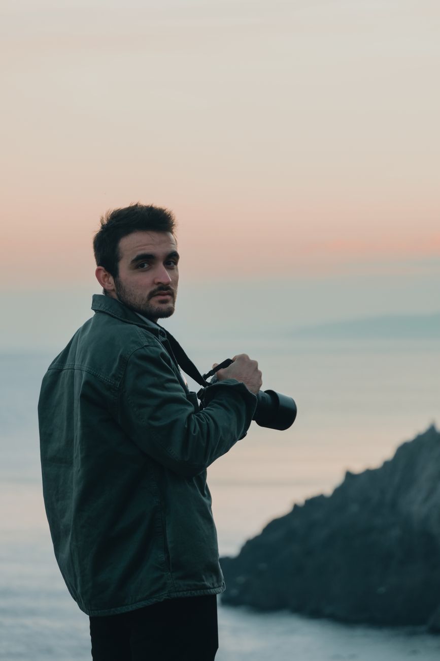 Photographer overlooking quiet mountain landscape
